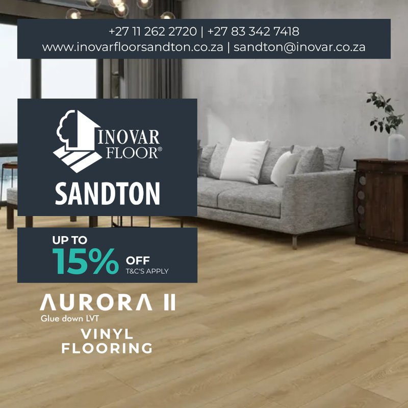 Modern grey sofa on honey-toned Aurora II glue-down LVT vinyl flooring, featuring the Inovar Floor Sandton 15% off sale.