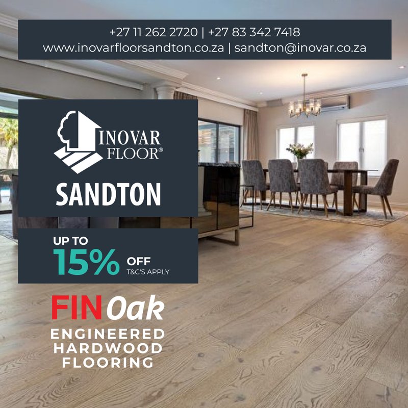 Luxurious dining room with a chandelier and grey upholstered chairs showcasing the premium texture of FIN Oak engineered hardwood flooring.