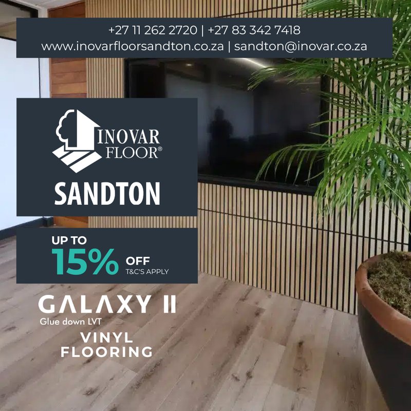 Close-up of Galaxy II glue-down LVT vinyl flooring in a room with a slatted wood accent wall and indoor greenery.